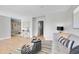 Open-concept living room with hardwood floors and neutral color palette at 7011 Poplar St, Commerce City, CO 80022