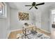 Bright office with a modern ceiling fan, desk, hardwood floors, and trendy decor at 7011 Poplar St, Commerce City, CO 80022