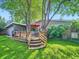 Beautiful backyard with a deck, mature trees, outdoor seating, and lush green lawn at 2609 S Dahlia St, Denver, CO 80222