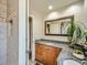 Bathroom with wood cabinets, granite countertops, a decorative mirror, and tiled floors for a luxurious touch at 2609 S Dahlia St, Denver, CO 80222