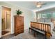 Bright bedroom with a ceiling fan, windows with shutters, and an ensuite bathroom with a shower at 2609 S Dahlia St, Denver, CO 80222