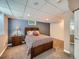Cozy bedroom featuring neutral carpet, double door closet, and a blue accent wall at 2609 S Dahlia St, Denver, CO 80222
