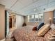 Inviting basement bedroom with a colorful patterned bedspread and ensuite bathroom offering comfort and privacy at 2609 S Dahlia St, Denver, CO 80222