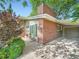 Charming exterior of a home featuring a brick chimney, cozy patio, and attached covered parking at 2609 S Dahlia St, Denver, CO 80222