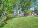 Attractive home with a green lawn and mature trees surrounding the house, creating a serene outdoor space at 2609 S Dahlia St, Denver, CO 80222