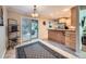 Open kitchen featuring stainless steel appliances, wood cabinets, and a view of the outdoor patio area at 2609 S Dahlia St, Denver, CO 80222