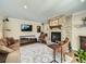 Cozy living room with a stone fireplace, comfortable seating, and natural light from the windows at 2609 S Dahlia St, Denver, CO 80222