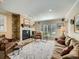 Inviting living room with stone fireplace, plush seating, and bright windows, perfect for relaxation at 2609 S Dahlia St, Denver, CO 80222