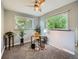 Bright home office featuring two large windows, a ceiling fan, and neutral decor for a productive workspace at 2609 S Dahlia St, Denver, CO 80222