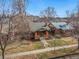 Aerial view of a charming brick home nestled among mature trees in a residential neighborhood at 2318 S Lincoln St, Denver, CO 80210