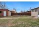 Spacious backyard with garden beds, fence, and storage shed at 2318 S Lincoln St, Denver, CO 80210