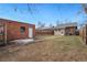 Large backyard with grass area, garden plots, and detached storage at 2318 S Lincoln St, Denver, CO 80210