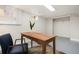 Finished basement space, with a simple desk and chair, and a light gray floor at 2318 S Lincoln St, Denver, CO 80210