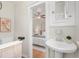 Bathroom sink with a glimpse into the adjacent bedroom with ceiling fan at 2318 S Lincoln St, Denver, CO 80210