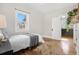 Bedroom with hardwood floors, natural light, and a view to the kitchen at 2318 S Lincoln St, Denver, CO 80210