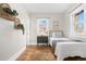 Bedroom featuring two windows, hardwood floors, decorative plants and a cozy rug at 2318 S Lincoln St, Denver, CO 80210