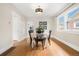 Bright dining room with hardwood floors, modern chandelier, and large window at 2318 S Lincoln St, Denver, CO 80210