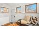 Inviting entryway featuring hardwood floors, wood-trimmed windows, and a cozy bench with decorative pillows at 2318 S Lincoln St, Denver, CO 80210