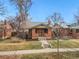 Charming brick home with mature trees, manicured lawn, and inviting front porch at 2318 S Lincoln St, Denver, CO 80210