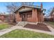 Charming brick home featuring a covered front porch with steps leading to the entrance at 2318 S Lincoln St, Denver, CO 80210