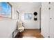 Bright hallway with hardwood floors, built-in storage, and a bench by the window at 2318 S Lincoln St, Denver, CO 80210