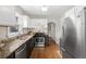 Well-lit kitchen featuring granite countertops, stainless steel appliances and hardwood floors at 2318 S Lincoln St, Denver, CO 80210