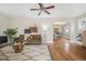 Bright living room showcasing hardwood floors, ceiling fan, and seamless transition to dining area at 2318 S Lincoln St, Denver, CO 80210