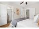 Main bedroom with attached bathroom featuring a tiled shower over tub and hardwood floors at 2318 S Lincoln St, Denver, CO 80210