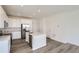 Modern kitchen with island, stainless steel appliances, and white cabinets at 1949 S Gold Bug Way, Aurora, CO 80018