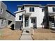 Two-story home showcasing stone accents, large windows, and a modern front door at 22833 E Tufts Ave # A, Aurora, CO 80015