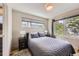 Cozy bedroom featuring soft lighting, a comfortable bed, and a large window at 3931 Utica St, Denver, CO 80212