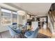 Bright dining area features a glass table, modern lighting, and an open layout connecting to the kitchen at 3931 Utica St, Denver, CO 80212
