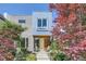 Modern home featuring a colorful front yard with lush gardens and a welcoming front porch with chairs at 3931 Utica St, Denver, CO 80212