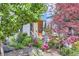 Landscaped front yard with flowering trees and stone accents leading to the home's inviting entrance at 3931 Utica St, Denver, CO 80212