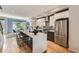 Contemporary kitchen featuring a large island with seating, white cabinets, and stainless steel appliances at 3931 Utica St, Denver, CO 80212