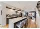 Modern kitchen with sleek white cabinets, a center island with seating, and stainless steel appliances at 3931 Utica St, Denver, CO 80212