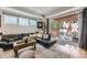 Open living room featuring a dark sectional sofa, a rustic coffee table, and access to an outdoor patio at 3931 Utica St, Denver, CO 80212
