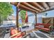 Outdoor patio with pergola, string lights, and comfortable seating around a hot tub at 3931 Utica St, Denver, CO 80212