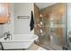 Elegant bathroom featuring a clawfoot tub and a glass-enclosed shower with tile surround at 5573 S Datura St, Littleton, CO 80120