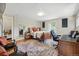 Comfortable bedroom with wood floors, rug, comfortable seating, desk, and two large windows at 5573 S Datura St, Littleton, CO 80120