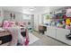 Bedroom features a daybed, desk, and storage shelves at 5573 S Datura St, Littleton, CO 80120