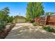 Long driveway leading to detached garage and deck with surrounding foliage and greenery at 5573 S Datura St, Littleton, CO 80120
