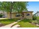 Charming single-story home with a well-manicured lawn and a mature shade tree at 5573 S Datura St, Littleton, CO 80120