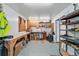 Well-lit garage with workbenches, storage shelves, and plenty of room for projects at 5573 S Datura St, Littleton, CO 80120