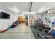 Large garage gym area with a TV, workout equipment, and space for activities at 5573 S Datura St, Littleton, CO 80120