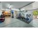 Spacious garage area converted to a gym, complete with workout equipment and ample storage space at 5573 S Datura St, Littleton, CO 80120