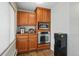 Kitchen nook features stainless oven and microwave, plus updated wood cabinetry for plenty of storage at 5573 S Datura St, Littleton, CO 80120