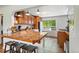 Inviting kitchen with hardwood cabinets, granite countertops, and a breakfast bar with seating at 5573 S Datura St, Littleton, CO 80120