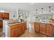 Open kitchen boasts tile floors, updated cabinets, a gas cooktop, and a breakfast bar with seating at 5573 S Datura St, Littleton, CO 80120