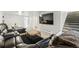 Spacious living room features a modern sofa and staircase to the right at 5573 S Datura St, Littleton, CO 80120